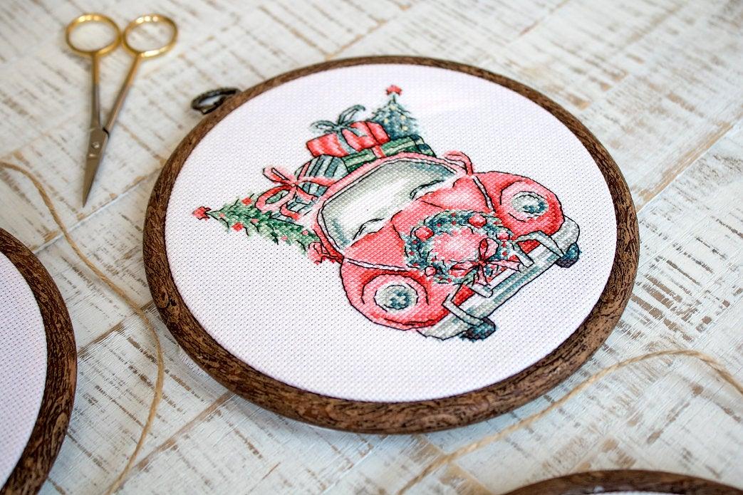 Counted Cross Stitch Kit featuring Christmas Retro Cars with colorful threads and canvas, perfect for holiday crafting.