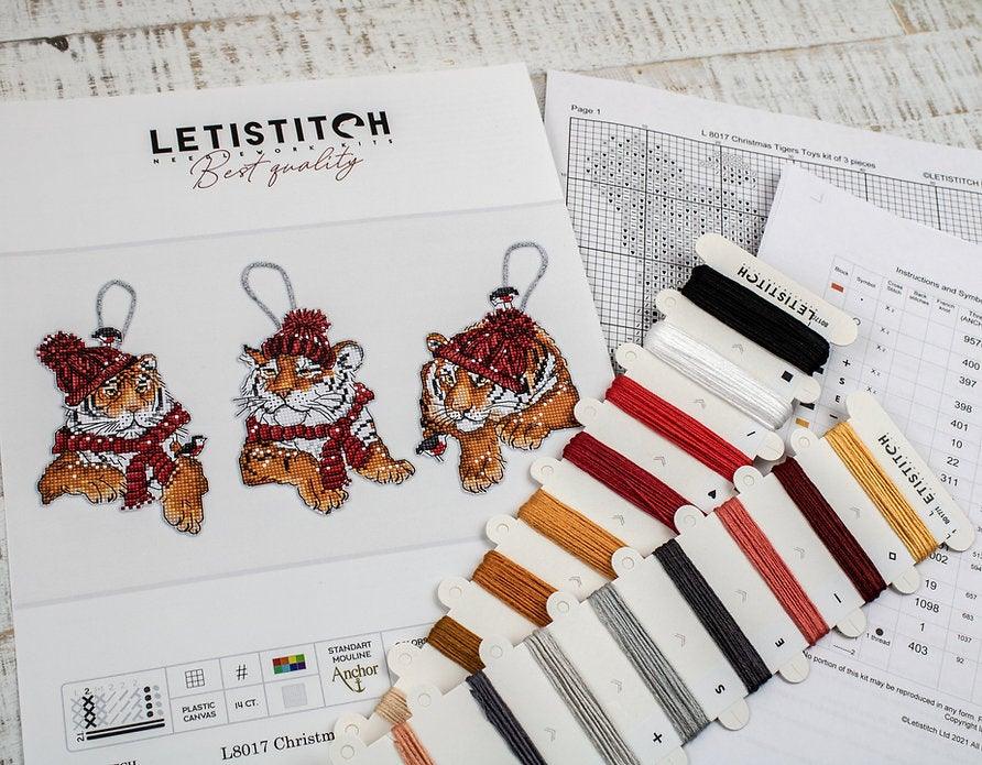 Counted Cross Stitch Kit featuring three Christmas Tiger designs with colorful threads and Aida canvas.