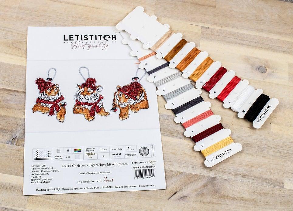 Counted Cross Stitch Kit featuring three Christmas Tiger designs with colorful threads and Aida canvas.