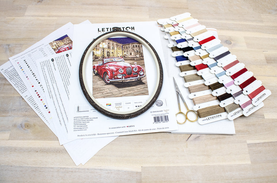 Counted Cross Stitch Kit featuring a vibrant red sports car design with included materials like canvas, threads, and needle.