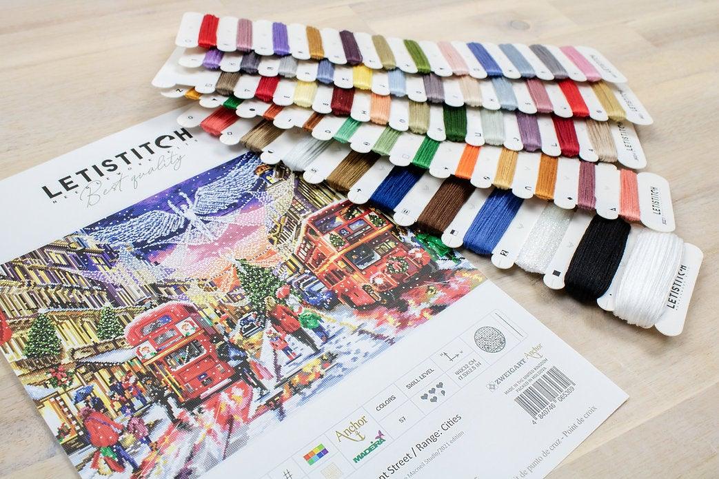 Counted Cross Stitch Kit Regent Street with Aida canvas, colorful threads, and instructions for stitching.