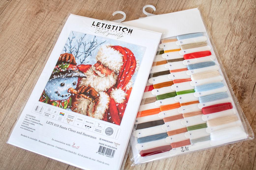 Counted Cross Stitch Kit featuring Santa Claus and Snowman with vibrant colors and detailed instructions.