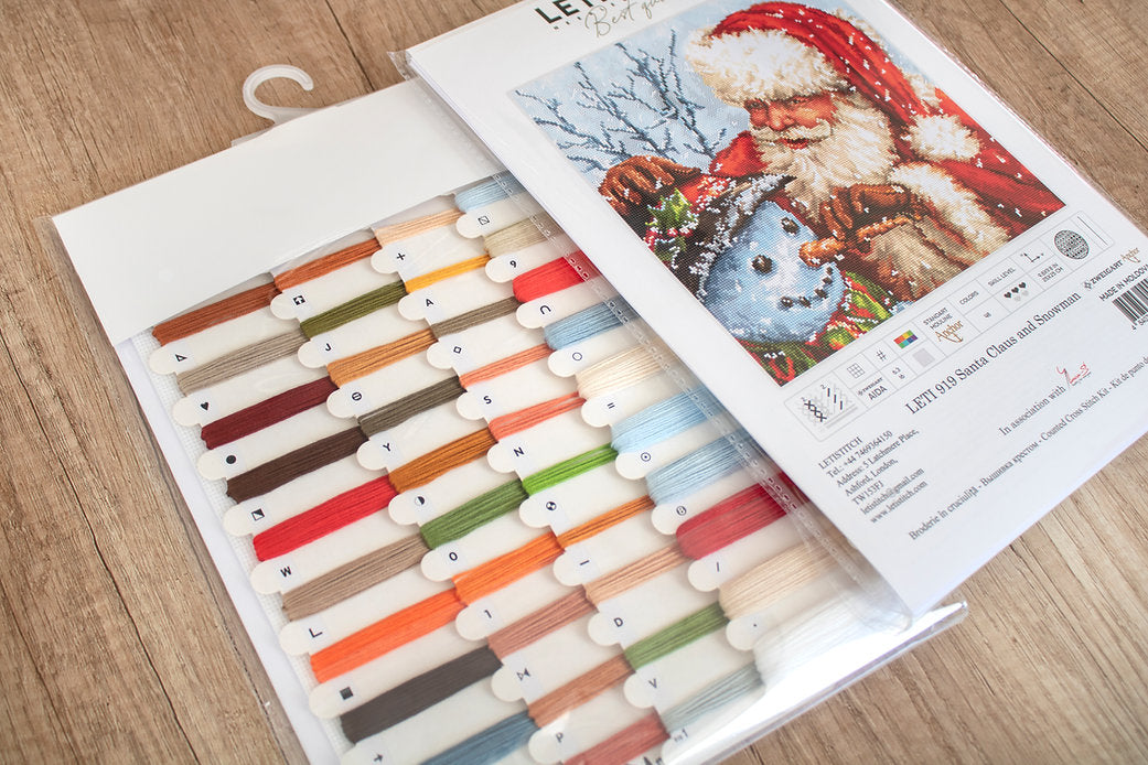 Counted Cross Stitch Kit featuring Santa Claus and Snowman with vibrant colors and detailed instructions.