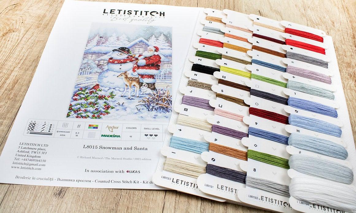 Counted Cross Stitch Kit featuring a Snowman and Santa design, including colorful threads and a needle on a canvas.