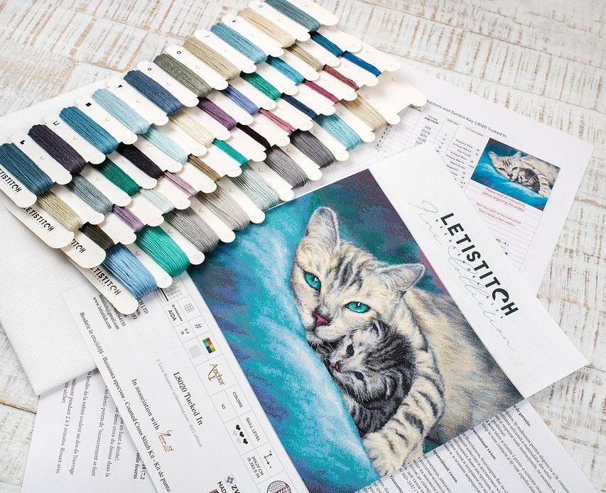 Counted Cross Stitch Kit Tucked In L8020 featuring vibrant threads, Aida canvas, and included needle and instructions.