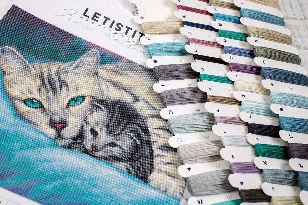 Counted Cross Stitch Kit Tucked In L8020 featuring vibrant threads, Aida canvas, and included needle and instructions.