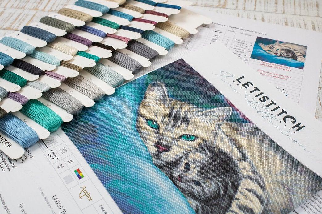 Counted Cross Stitch Kit Tucked In L8020 featuring vibrant threads, Aida canvas, and included needle and instructions.