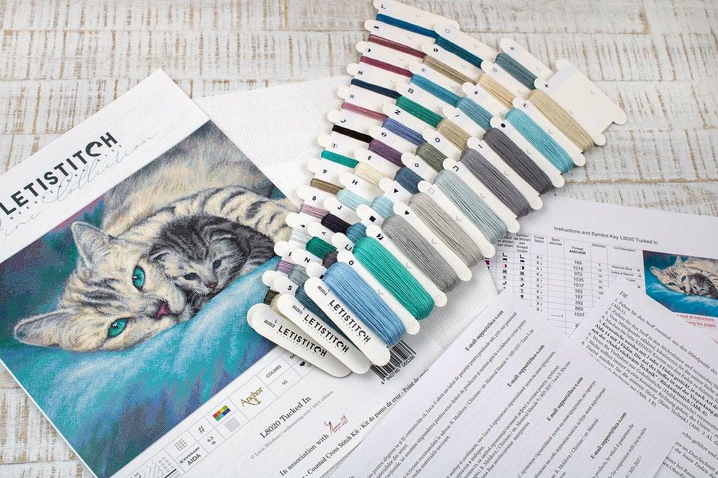 Counted Cross Stitch Kit Tucked In L8020 featuring vibrant threads, Aida canvas, and included needle and instructions.