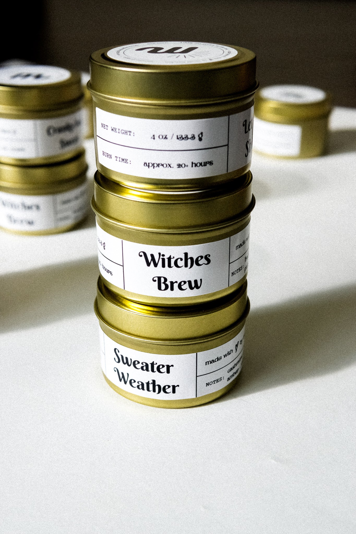 Cranky but Sweet Gold Travel Candle in a gold tin jar with a warm glow, featuring a label showcasing its cranberry apple marmalade scent.