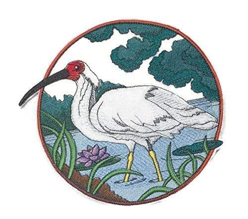 Crested Ibis embroidered patch in a circular design, showcasing vibrant colors and intricate stitching on a cotton base.