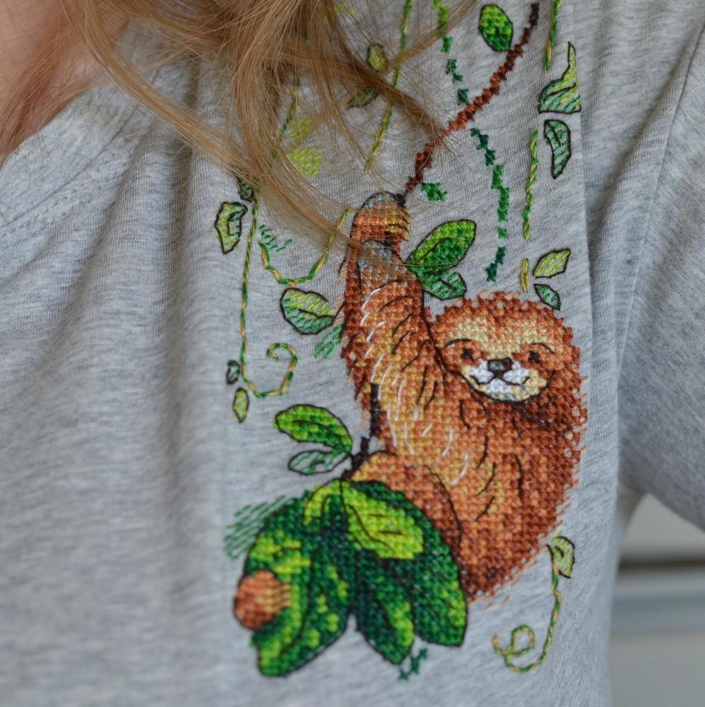 Cross stitch kit featuring a Perky Sloth design with colorful threads and water-soluble canvas.
