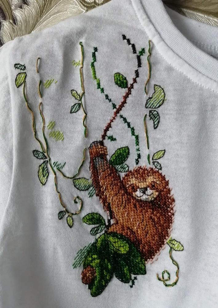 Cross stitch kit featuring a Perky Sloth design with colorful threads and water-soluble canvas.