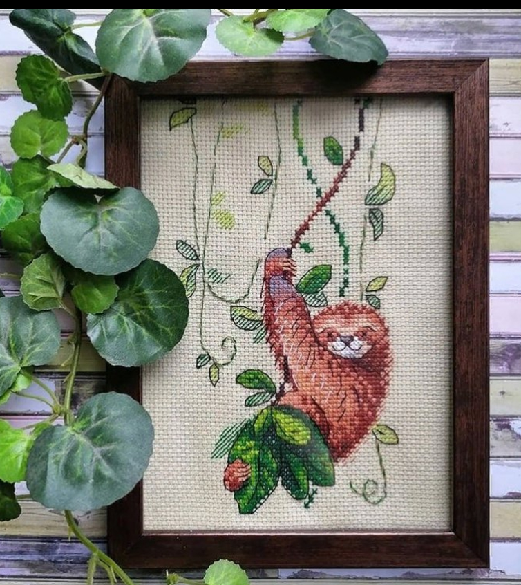 Cross stitch kit featuring a Perky Sloth design with colorful threads and water-soluble canvas.