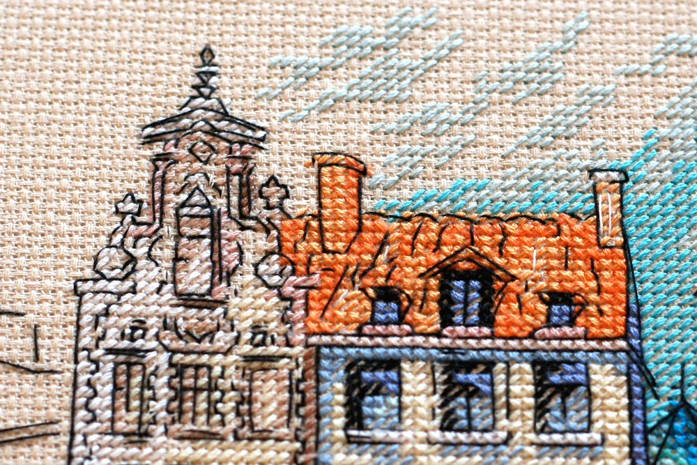 Cross-stitch kit Colored town-1 AH-137 featuring a beige canvas, 23 colorful floss threads, and organized stitching materials.