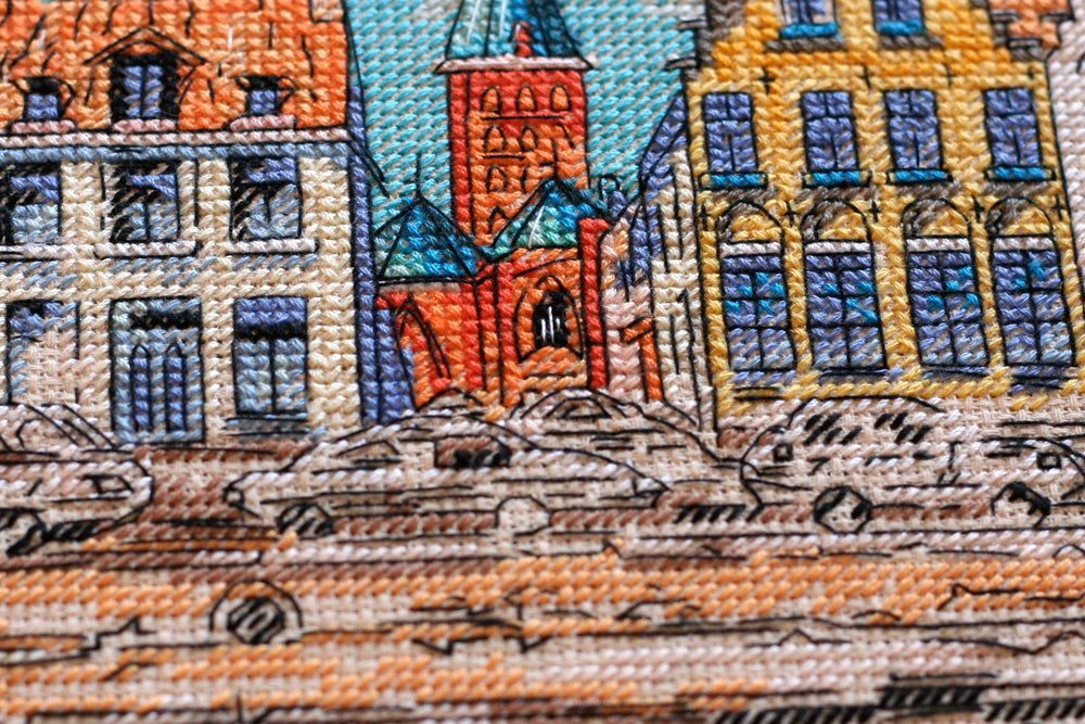 Cross-stitch kit Colored town-1 AH-137 featuring a beige canvas, 23 colorful floss threads, and organized stitching materials.