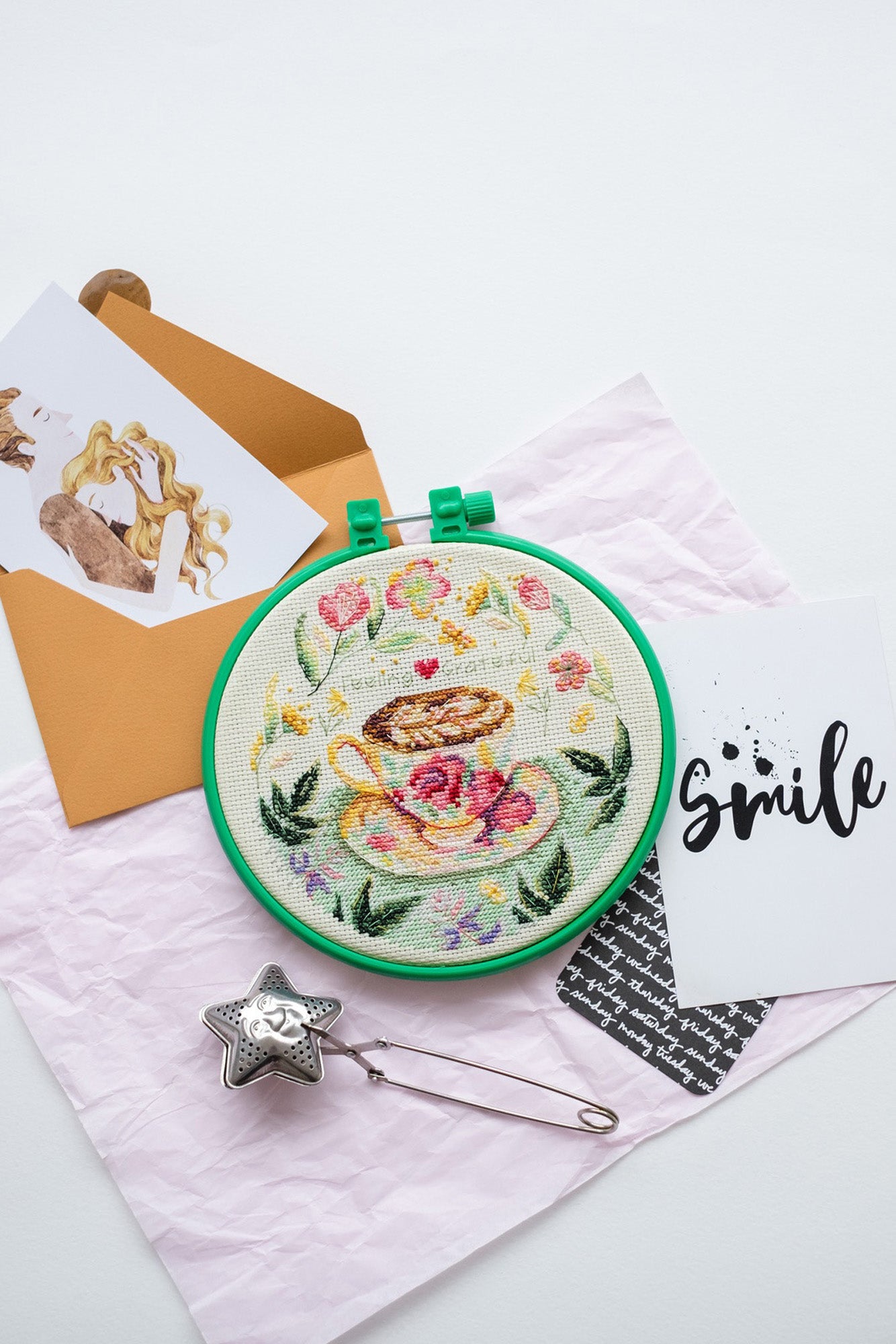 Cross-stitch kit Cup AHM-011 featuring cotton canvas, colorful floss, and needles for crafting.