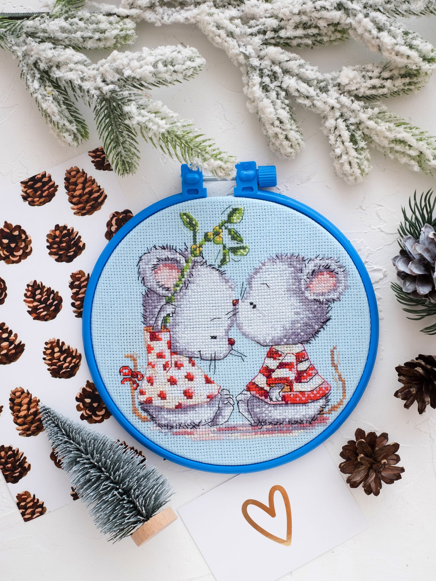 Cross-stitch kit featuring adorable mice in love, includes canvas, floss, needles, and instructions.