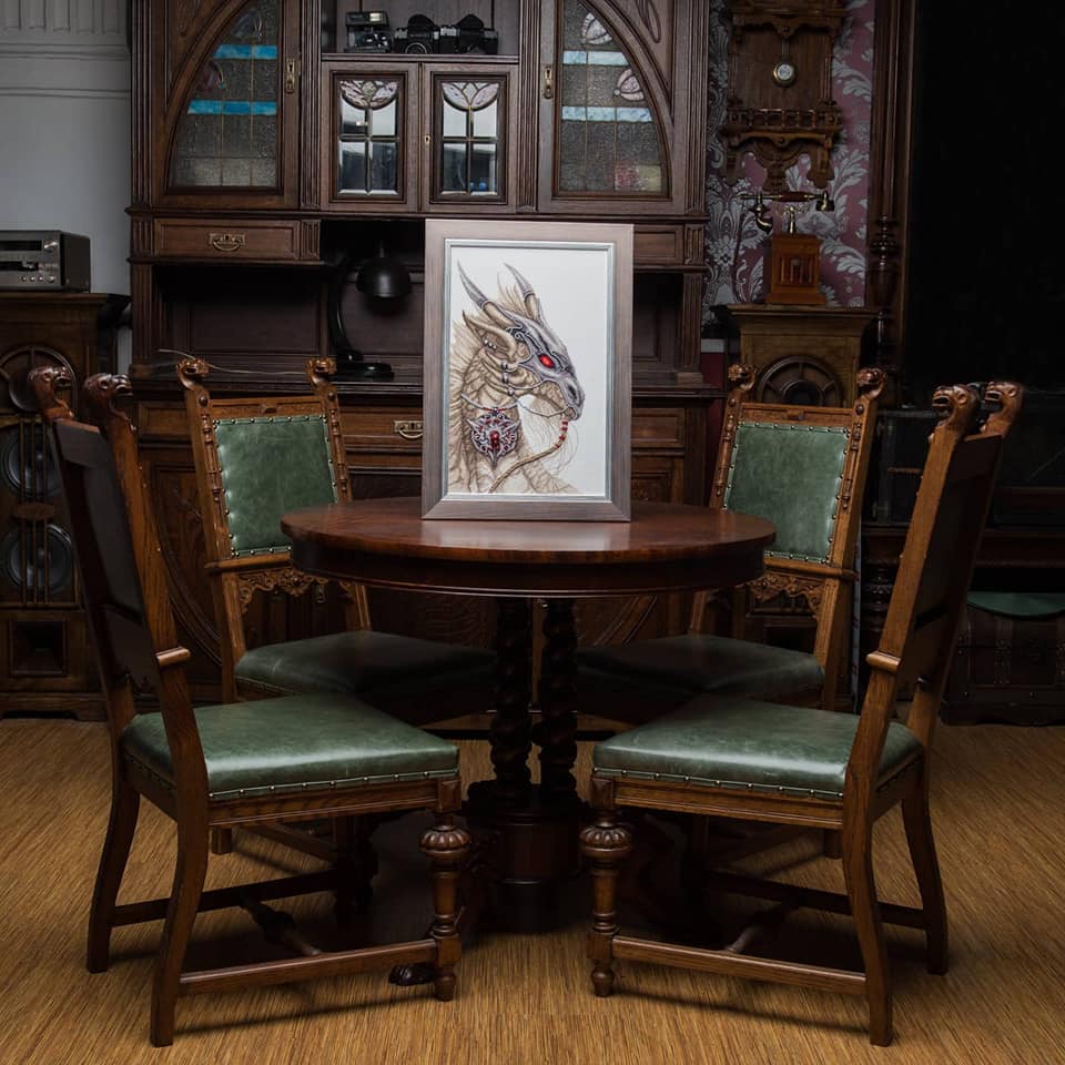 Cross-stitch kit M-319C 'Guardian of treasure' featuring colorful threads, beads, and Aida fabric.