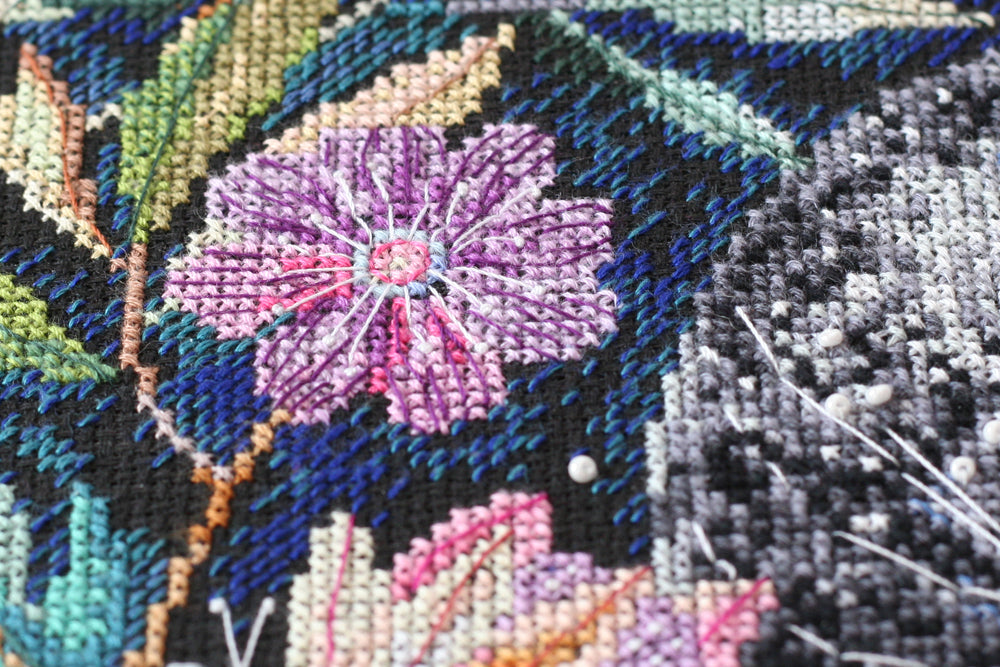 Cross-stitch kit Moon secrets AH-065 featuring black canvas, colorful floss, beads, and needles for crafting.
