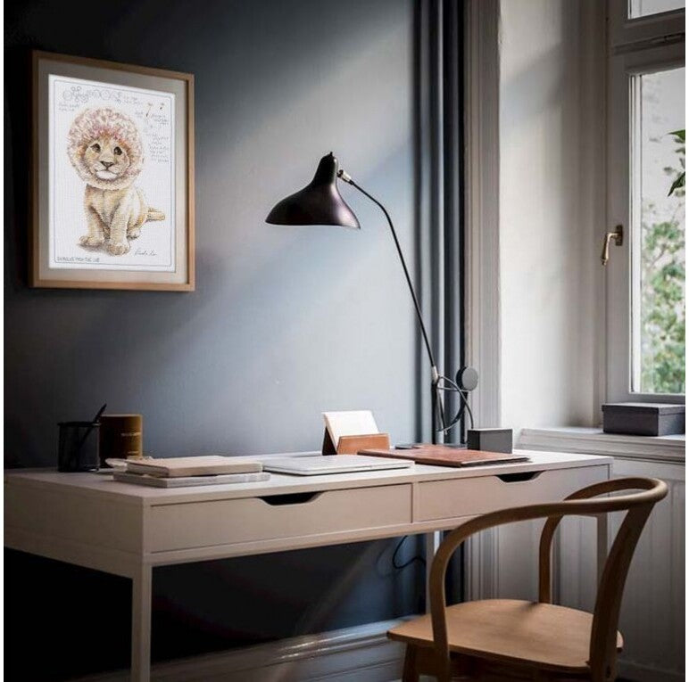 Cross-stitch kit featuring a printed dandelion design on white canvas with included threads and needle.