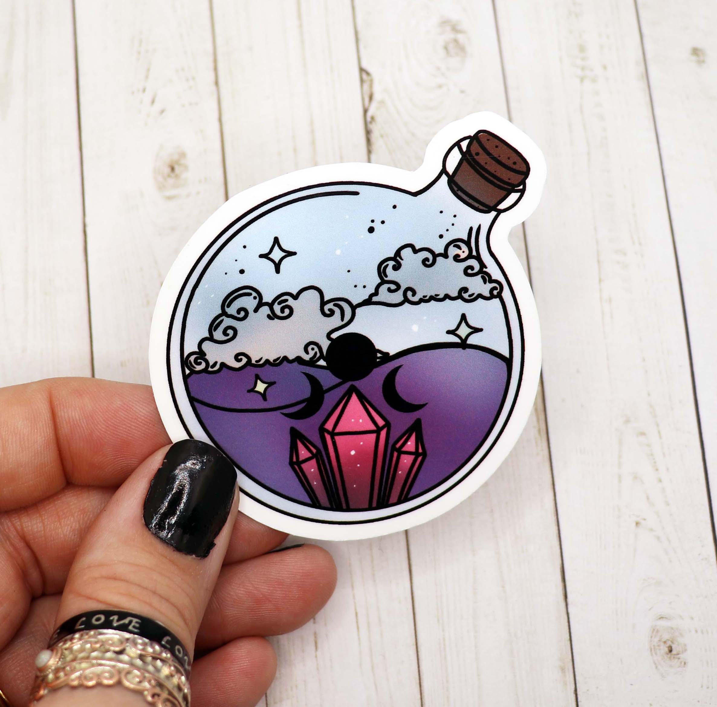 A vibrant Crystal Potion Bottle Sticker on a white background, showcasing its intricate design and colors.