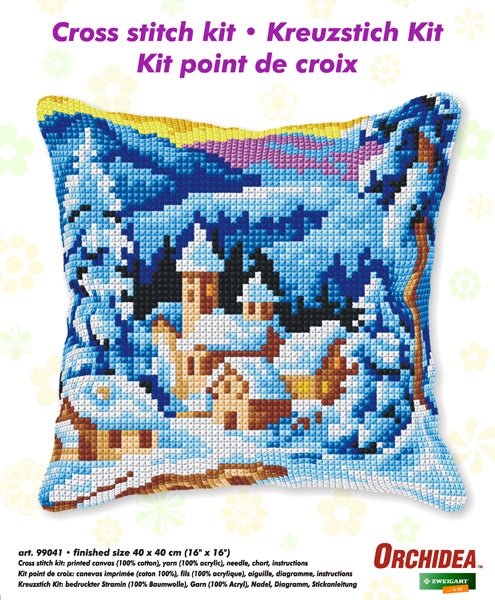 Cushion cross stitch kit featuring a winter village design with printed Zweigart canvas and colorful acrylic yarn.