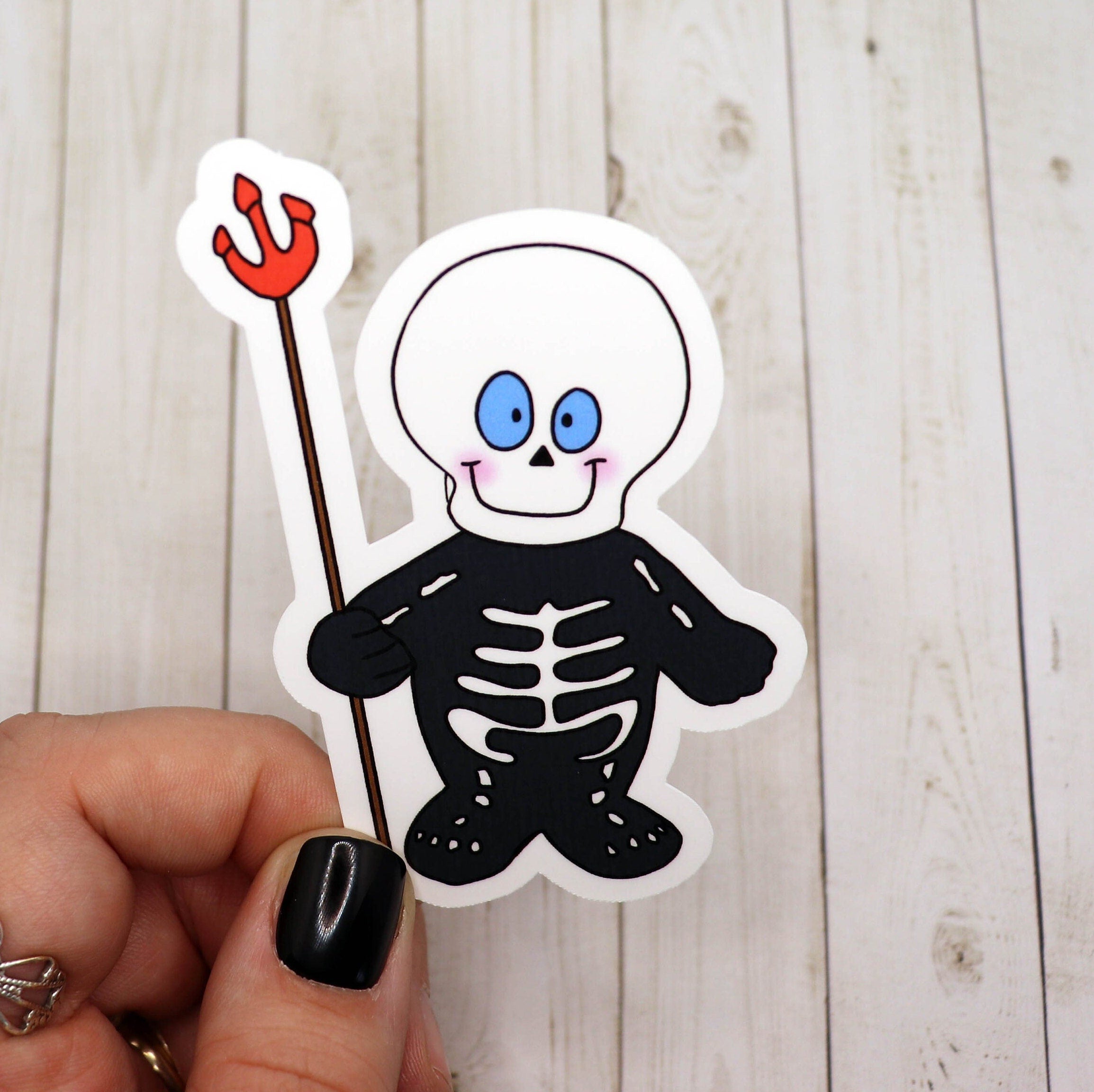 A cute skeleton sticker featuring a playful design, perfect for personalizing various items.