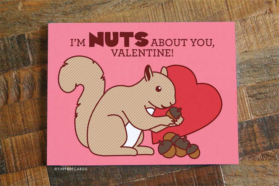 Cute Valentine card featuring a squirrel pun saying 'Nuts About You', designed for Valentine's Day.