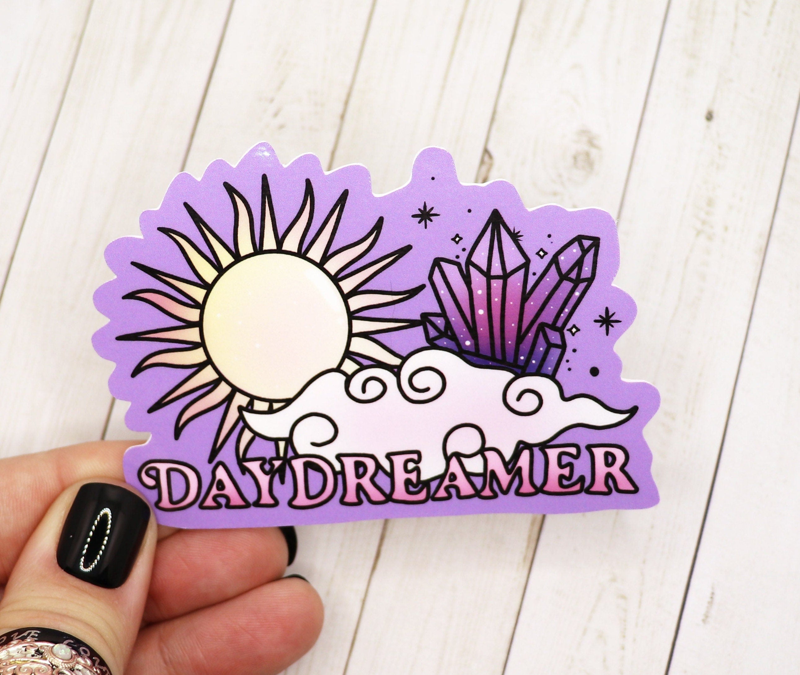 A vibrant Daydreamer sticker featuring dreamy designs, perfect for personalizing various items.