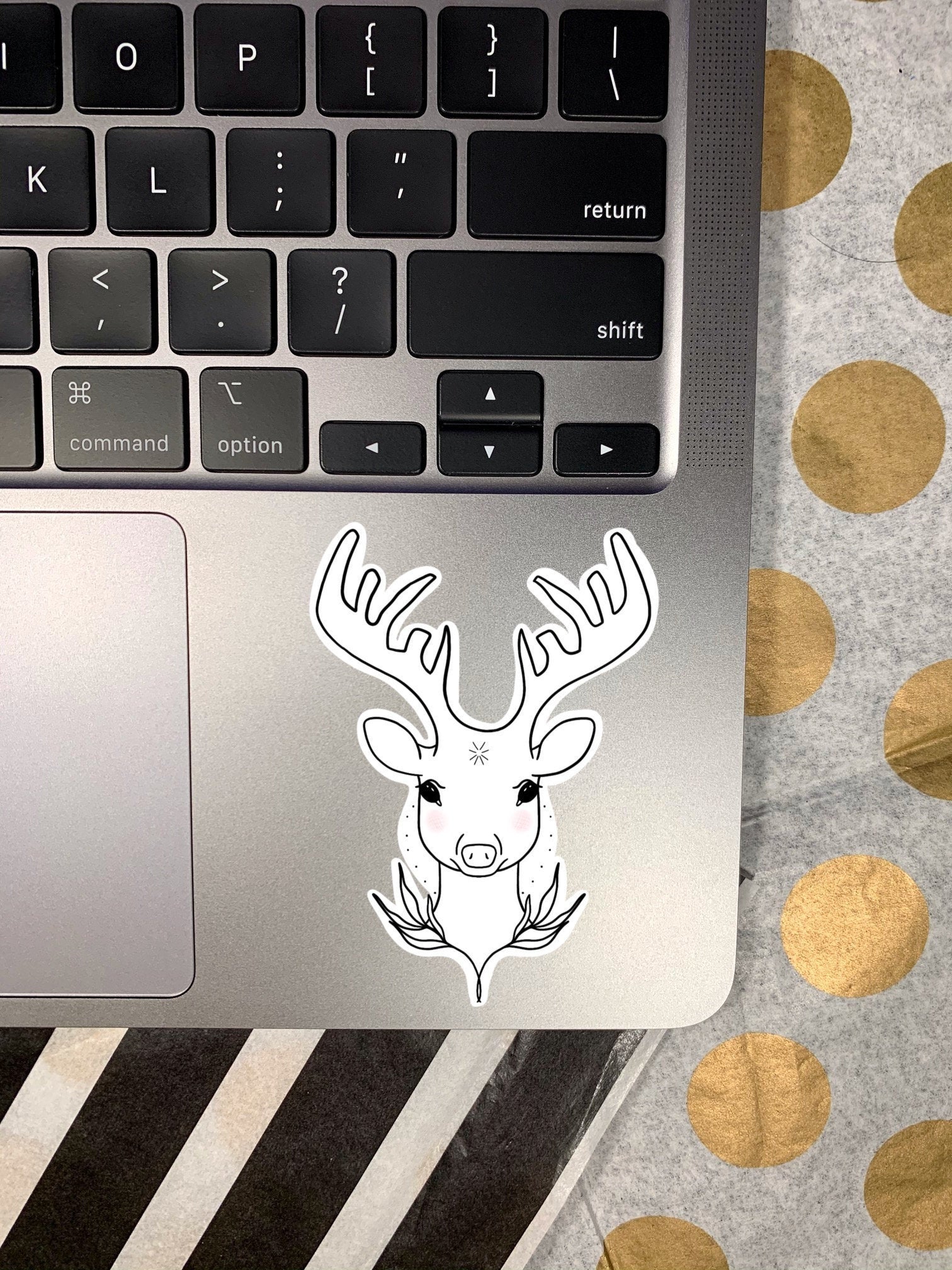 Deer sticker on laptop keyboard.