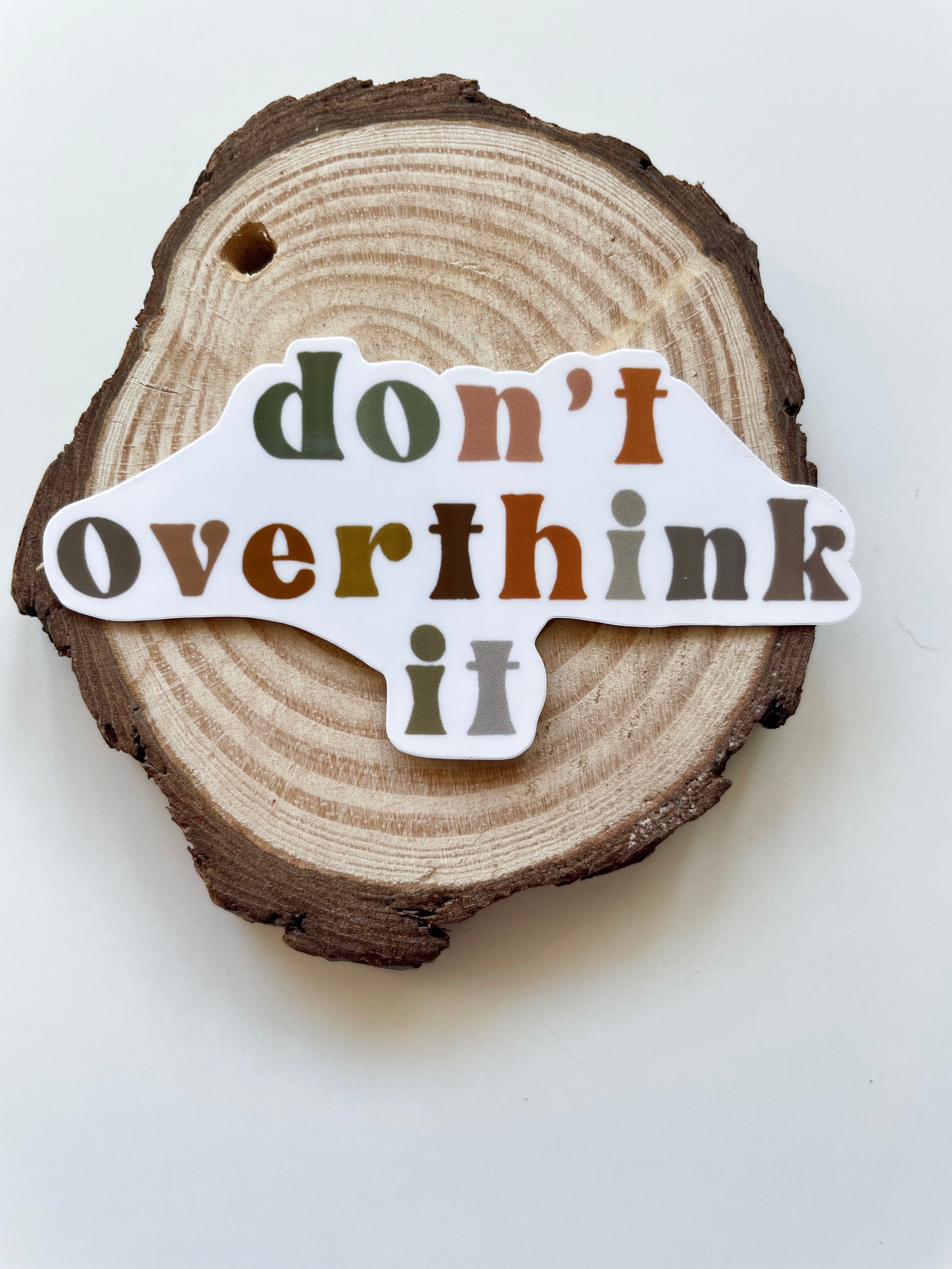 A colorful 'Don't Overthink It' sticker on a white background, featuring motivational text and a stylish design.