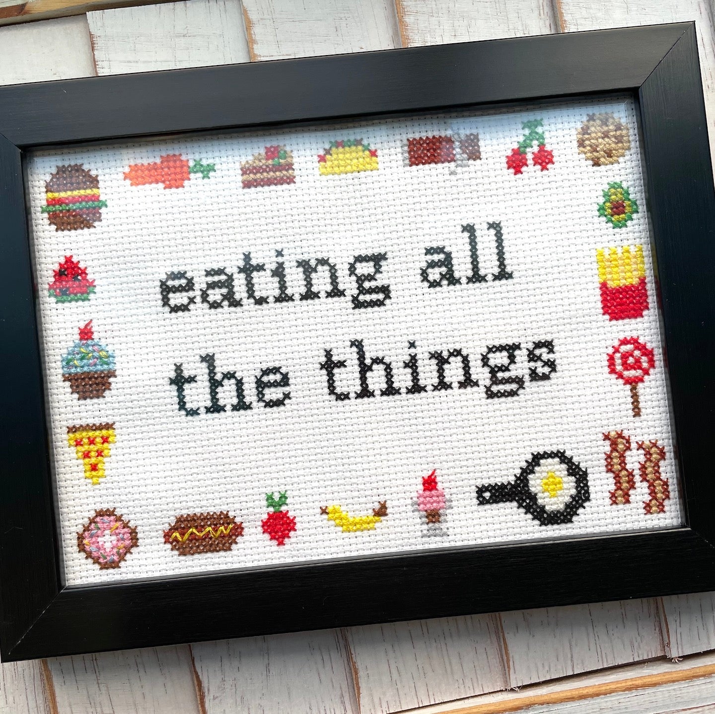 Eating All The Things Counted Cross Stitch Kit with supplies including fabric, threads, and needle, showcasing a food-themed design.