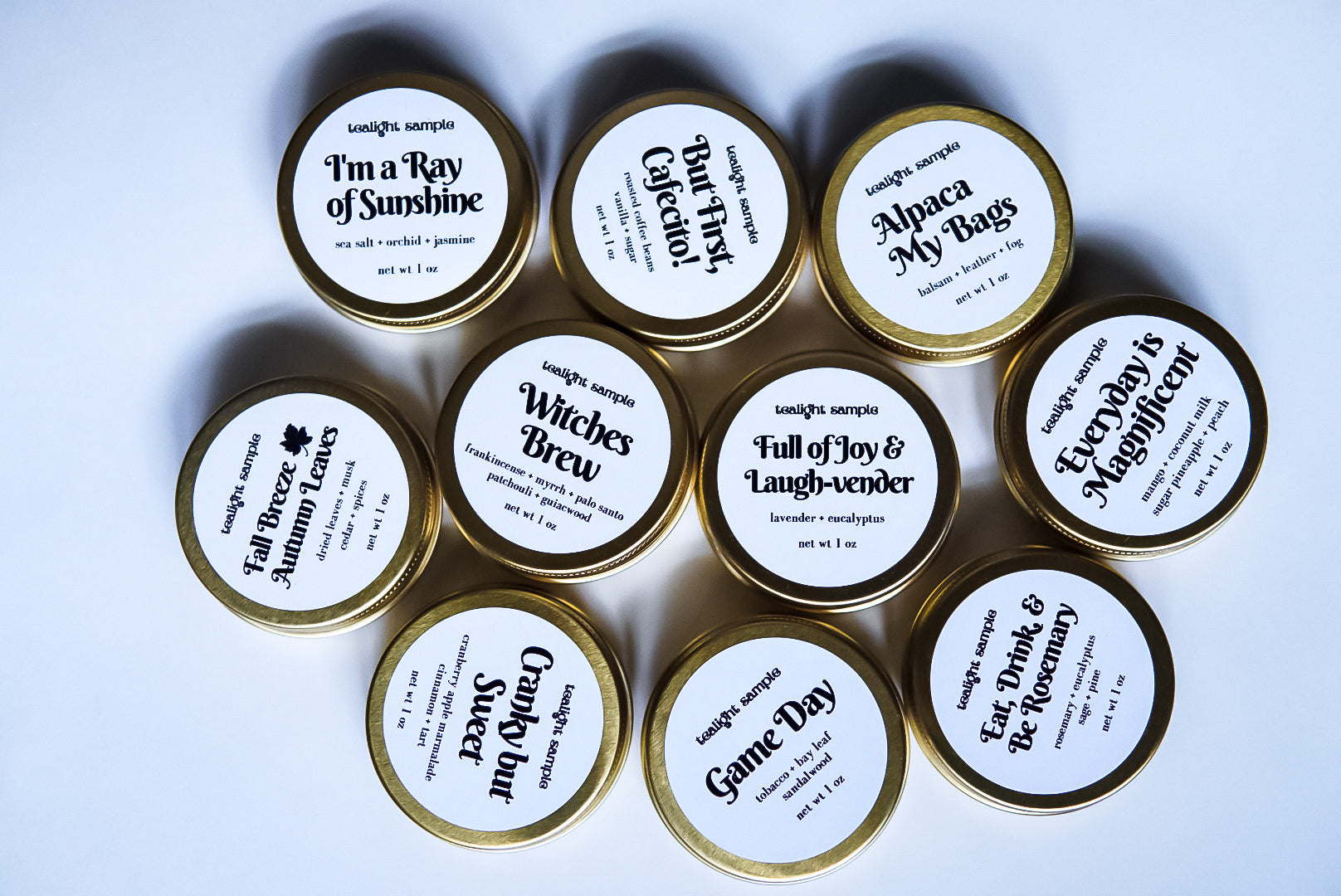 Fall Discovery Kit featuring 7 tea lights in gold tins, showcasing autumn fragrances like Apple Pie and Pumpkin Spice.