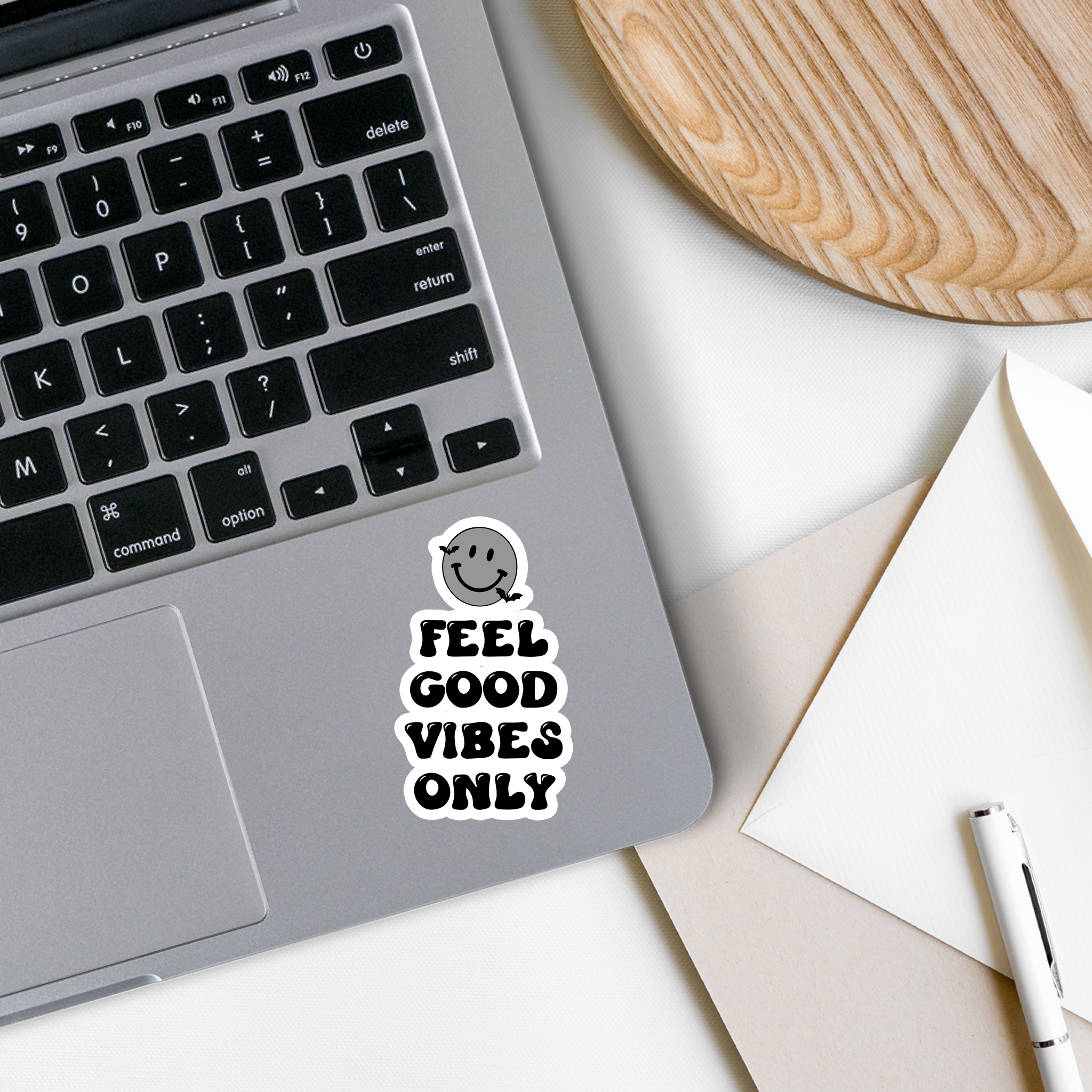 A vibrant vinyl sticker featuring a cheerful smiley face with the text 'Feel Good Vibes Only', perfect for personalizing various items.