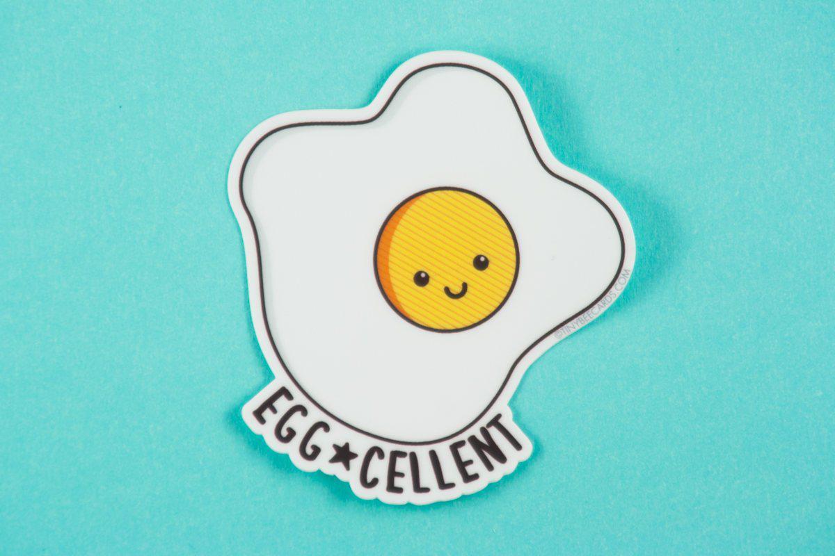 A cute kawaii fried egg vinyl decal featuring a happy egg with the pun 'Egg-cellent', perfect for personalizing items.