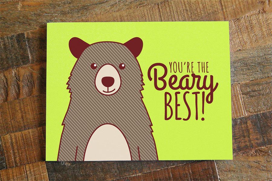 A cheerful greeting card featuring a happy bear and the text 'You're the Beary Best!' with a playful design.