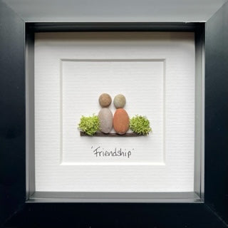 Handcrafted friendship pebble art featuring unique designs symbolizing friendship, made from natural pebbles.