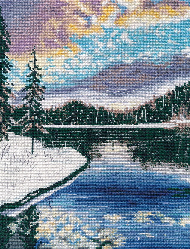 Frosty Evening 1390 Counted Cross Stitch Kit featuring a winter river landscape with snowy forest and blue sky.
