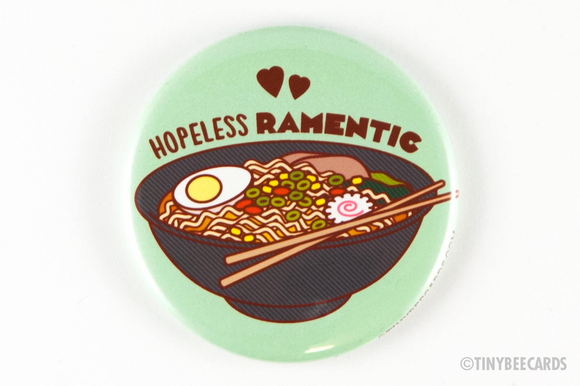 A 2.25-inch round magnet featuring a colorful ramen bowl and the text 'Hopeless Ramentic', perfect for gifts.
