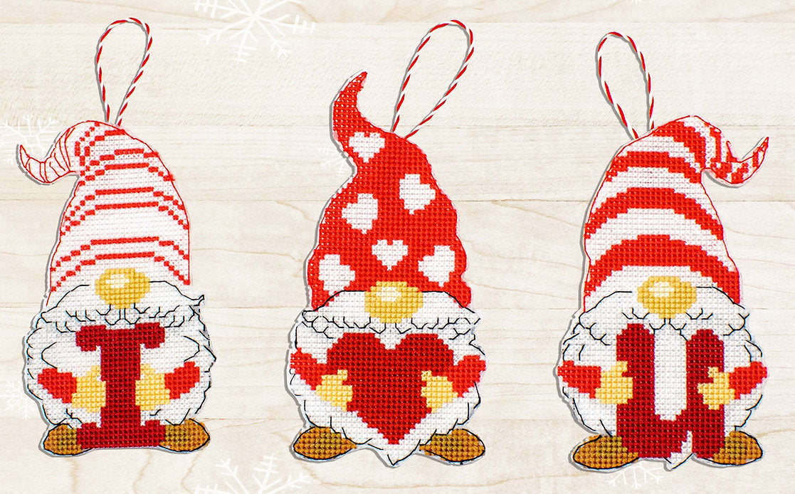 Gnomes of Valentine's Day cross-stitch kit featuring colorful threads, needle, and Aida canvas.