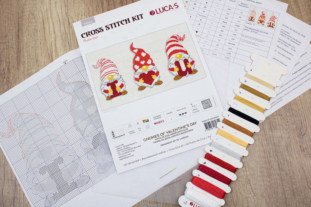 Gnomes of Valentine's Day cross-stitch kit featuring colorful threads, needle, and Aida canvas.