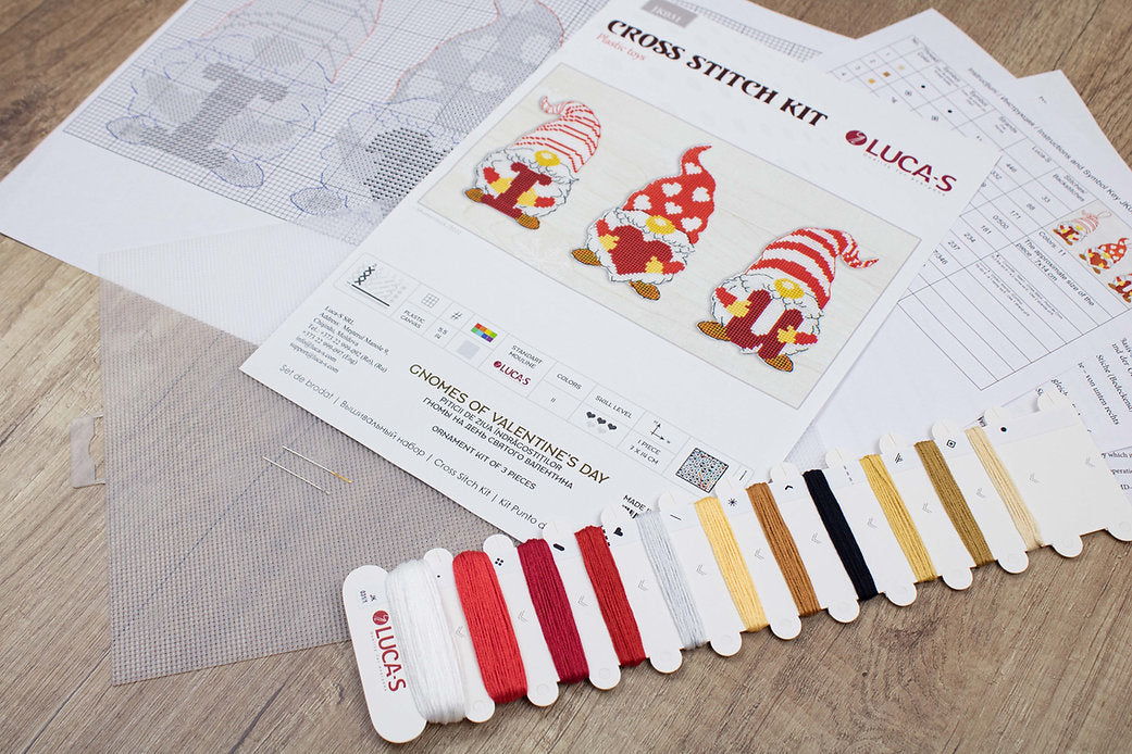 Gnomes of Valentine's Day cross-stitch kit featuring colorful threads, needle, and Aida canvas.