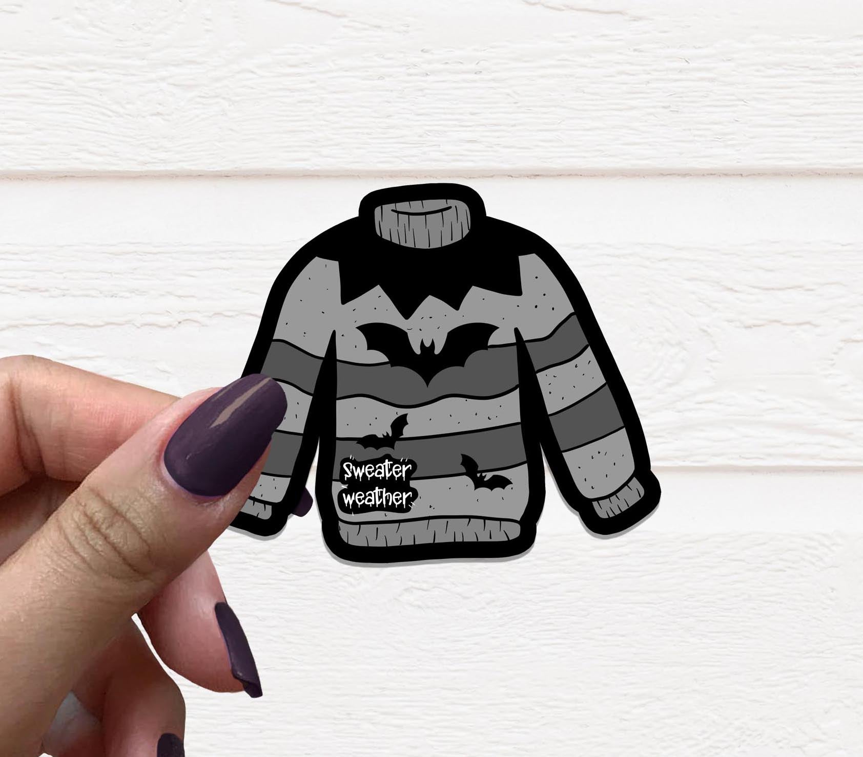 Goth Sweater Weather Vinyl Sticker featuring a stylish design, perfect for personalizing various items.