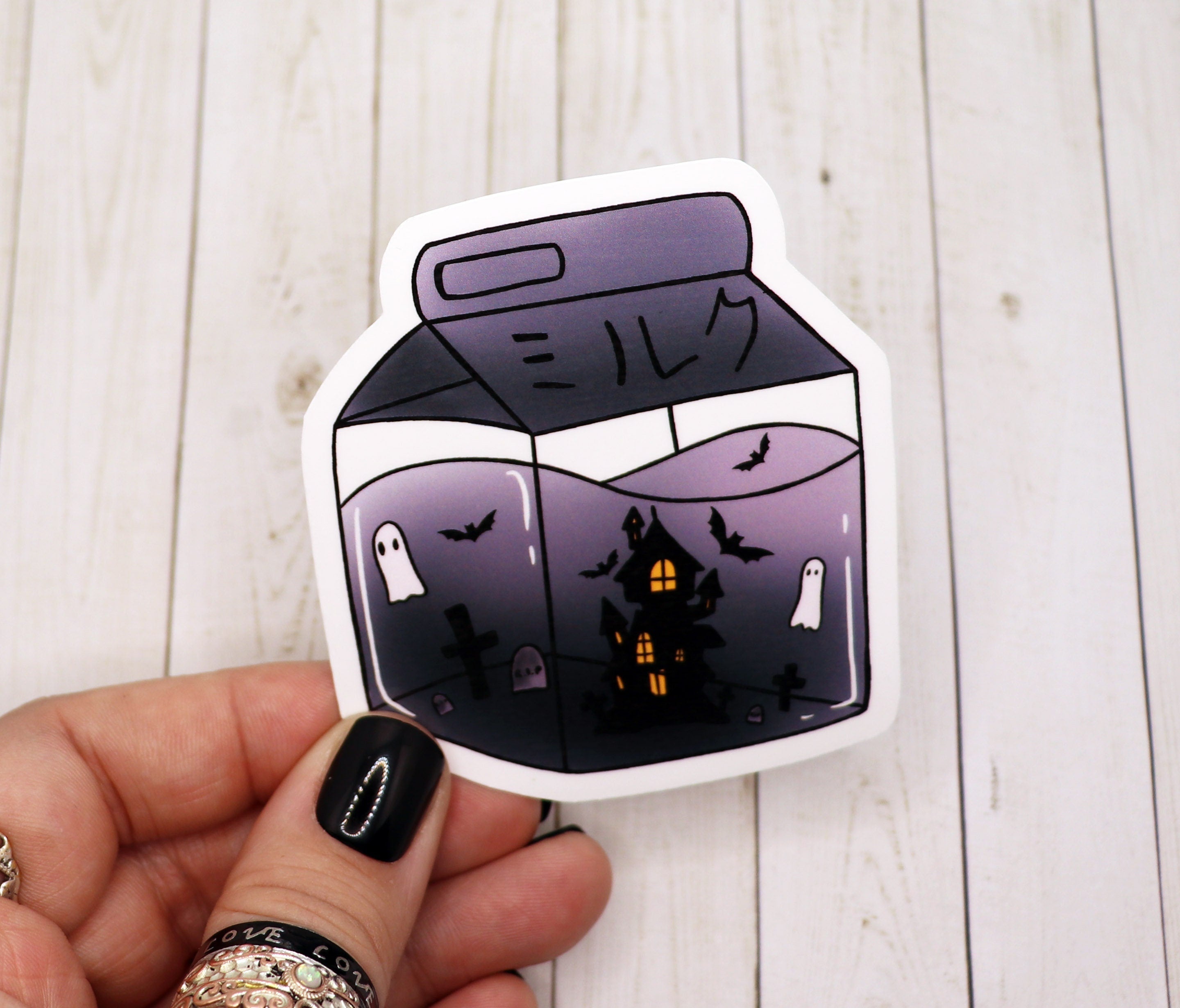A spooky haunted milk carton sticker featuring a ghostly design, perfect for Halloween decorations.