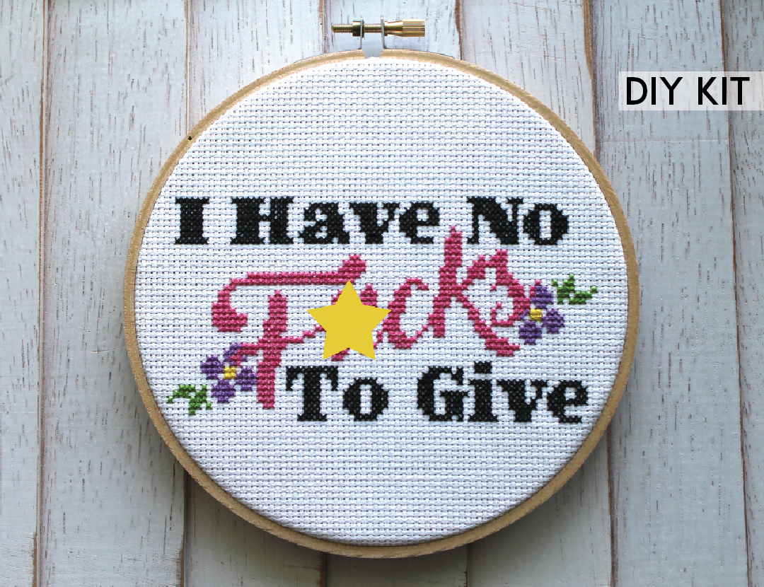 Counted cross stitch DIY kit featuring 'I Have No F*cks To Give' text surrounded by floral designs, includes all necessary supplies.