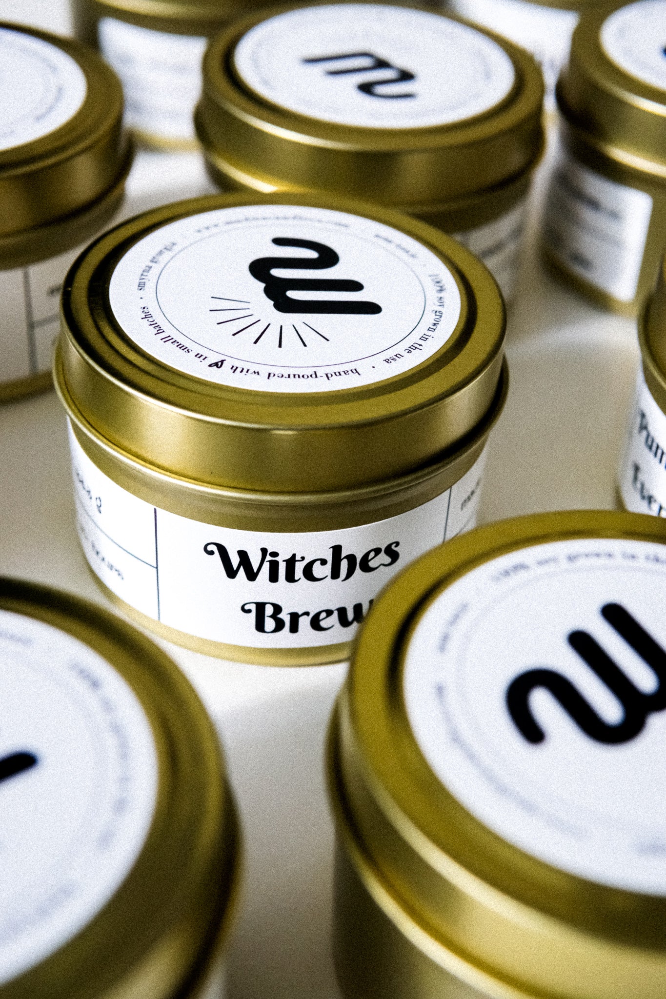 I Put a Spell on You Gold Travel Candle in a gold tin jar with a warm glow, featuring a label inspired by Hocus Pocus.