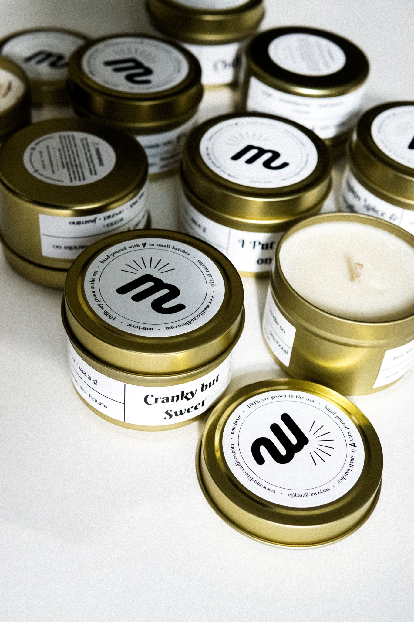 I Put a Spell on You Gold Travel Candle in a gold tin jar with a warm glow, featuring a label inspired by Hocus Pocus.