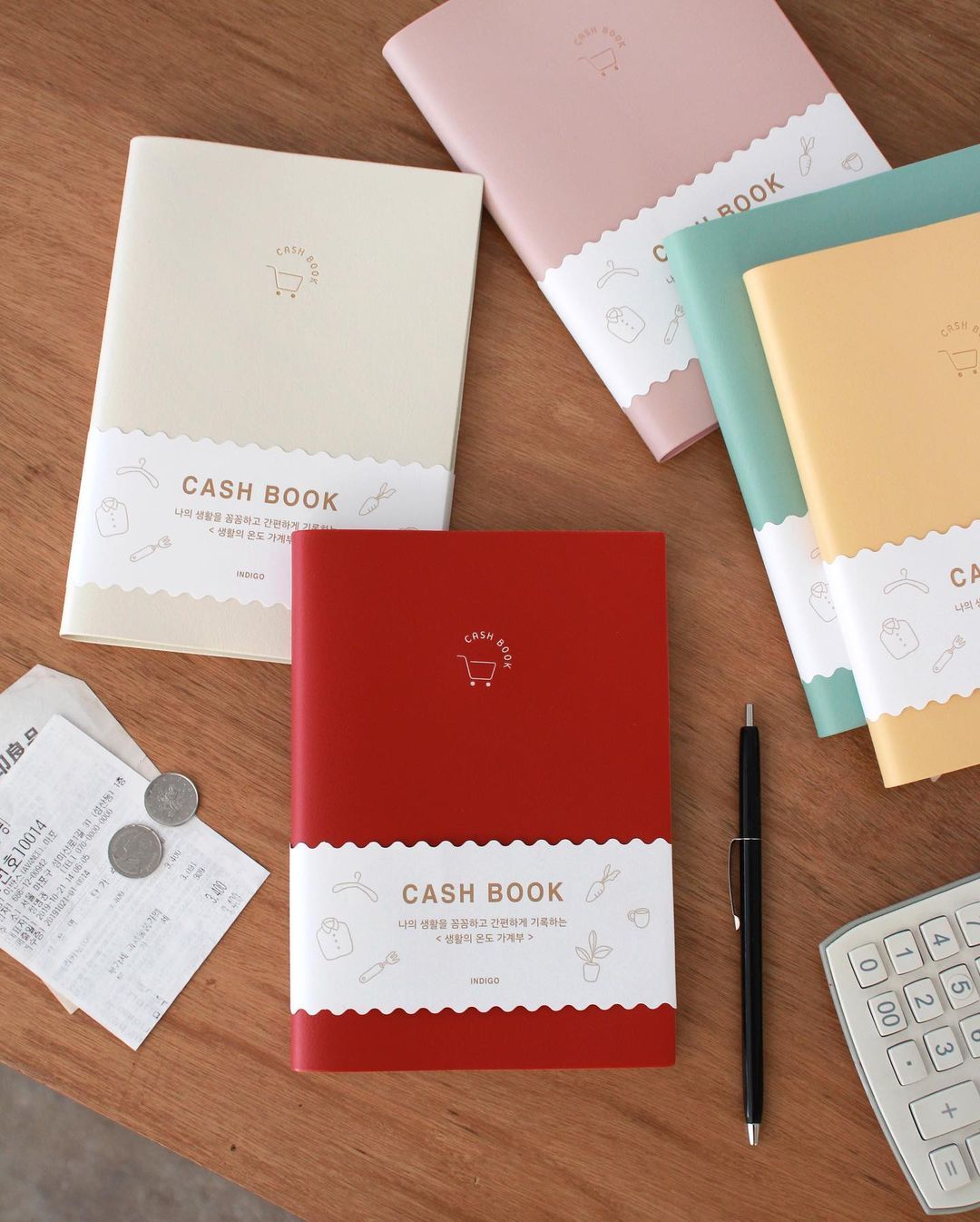 INDIGO SIMPLE CASH BOOK featuring a stylish cover and undated pages for tracking expenses over 12 months.