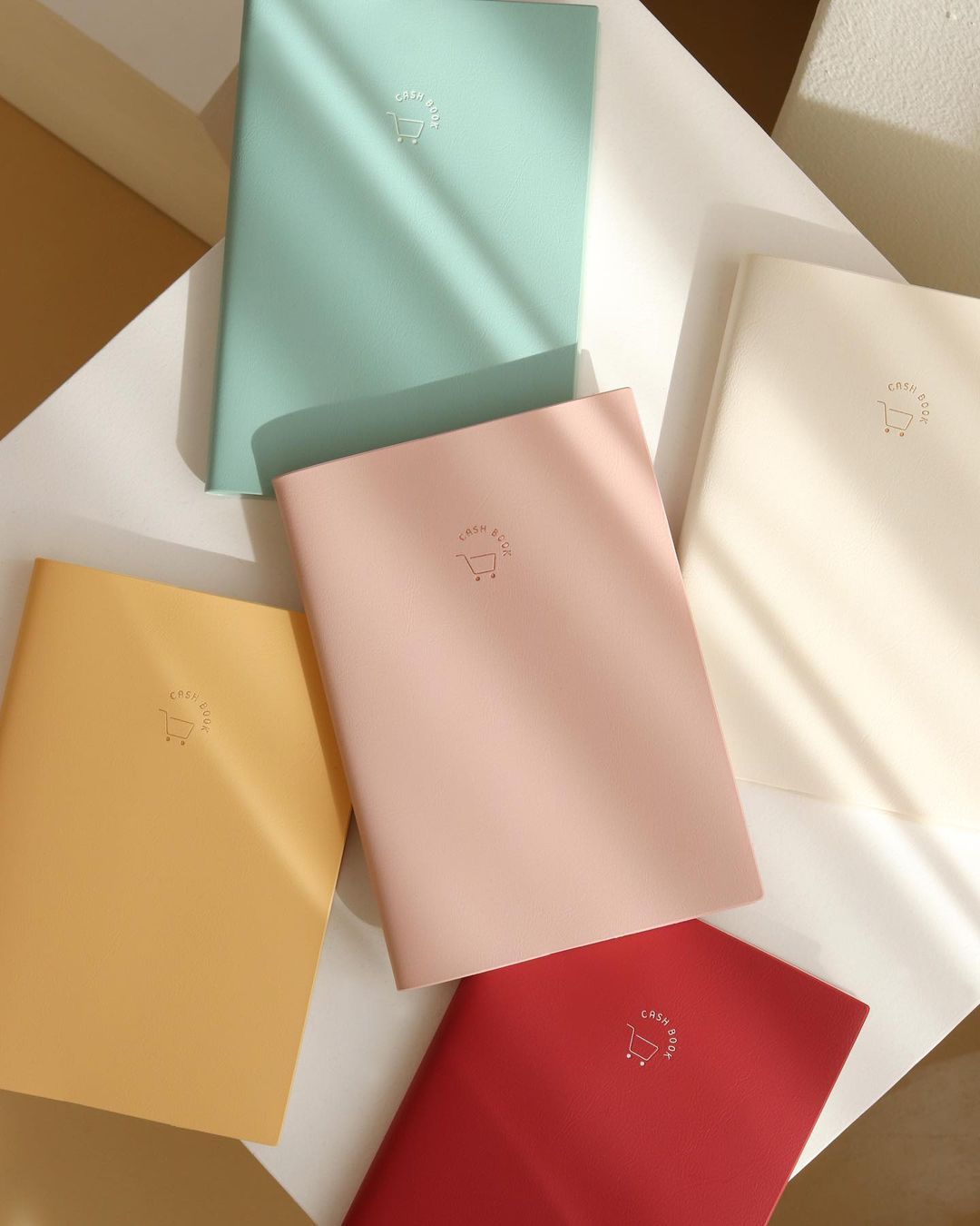 INDIGO SIMPLE CASH BOOK featuring a stylish cover and undated pages for tracking expenses over 12 months.