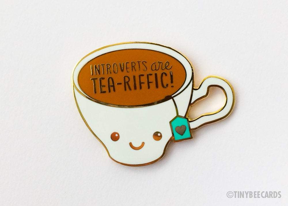 Cute kawaii enamel pin featuring a teacup with the text 'Introverts are Tea-Riffic', designed for introverts and tea lovers.